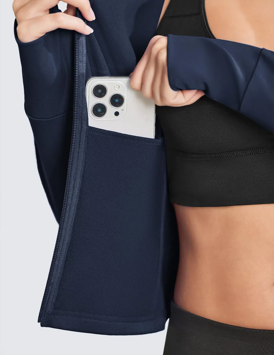 PINSPARK Chaqueta de running para mujer, deportiva corta, de entrenamiento de manga larga, chaqueta de yoga, bolsillos con cremallera y orificios para los pulgares.
