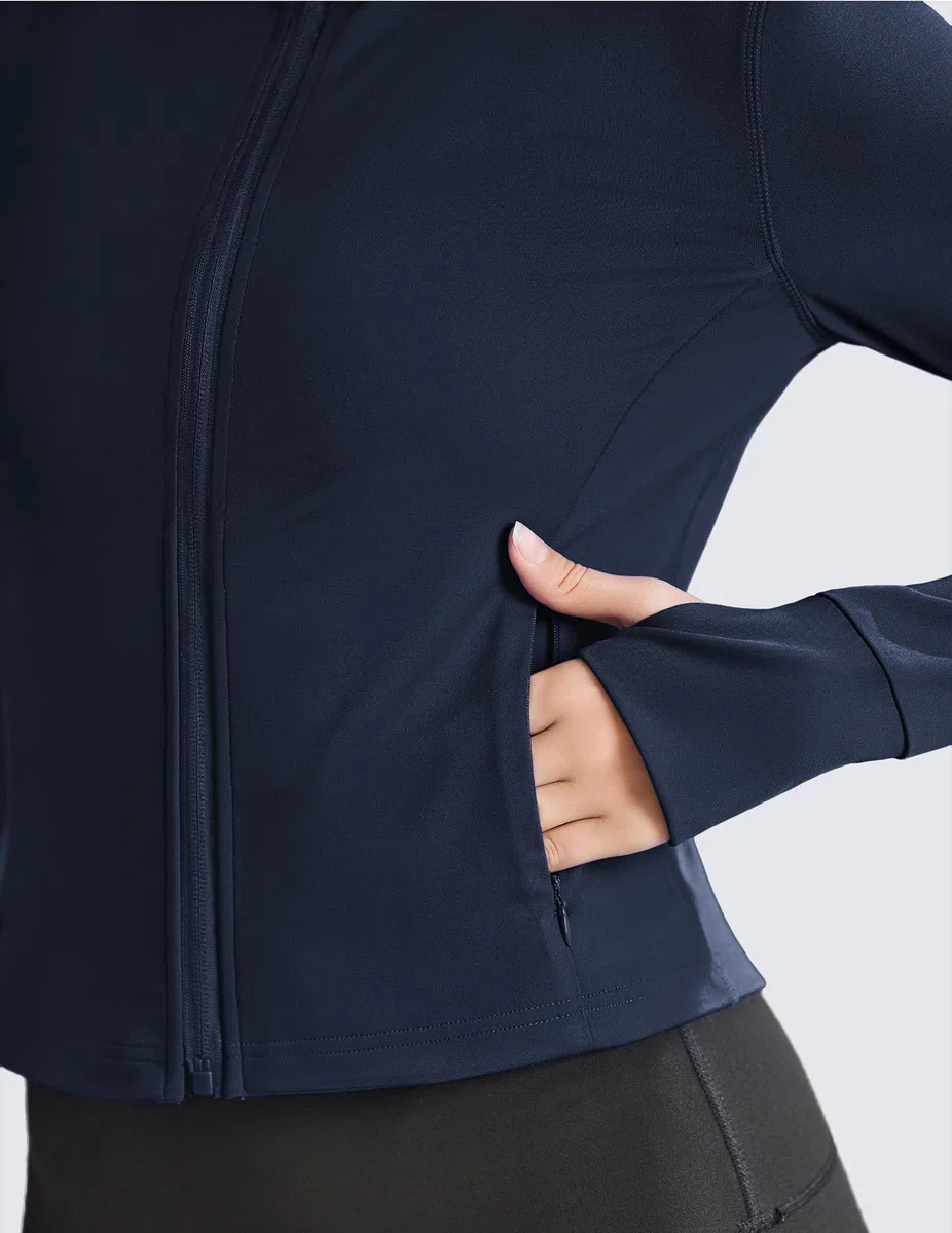 PINSPARK Chaqueta de running para mujer, deportiva corta, de entrenamiento de manga larga, chaqueta de yoga, bolsillos con cremallera y orificios para los pulgares.